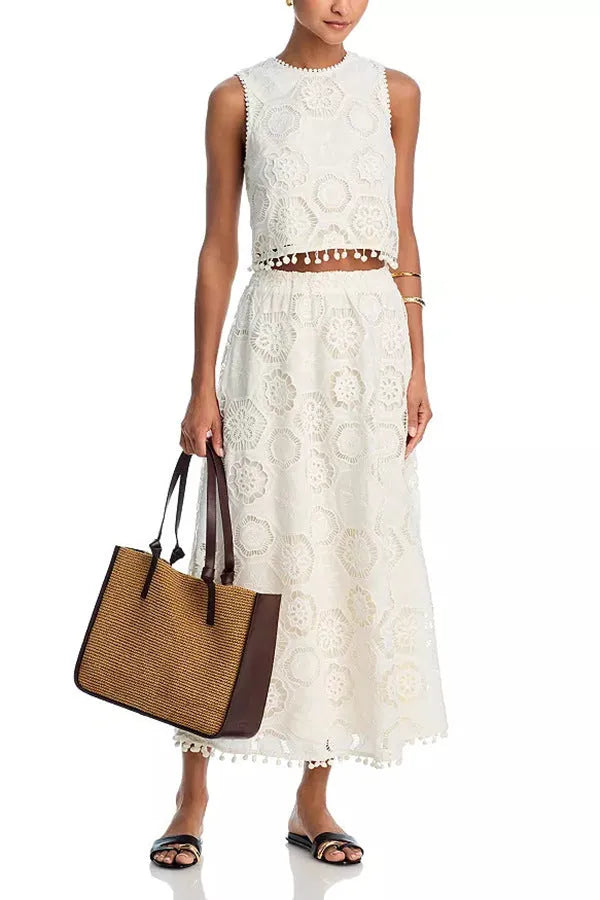 White women's retro style sleeveless top and long skirt suit set with embroidery detail.