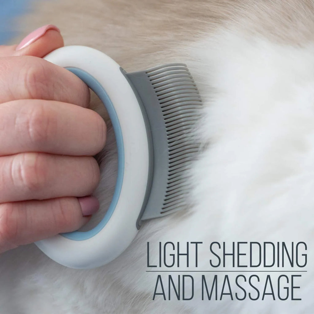Blue plastic pet grooming comb for cats and dogs on a white background.