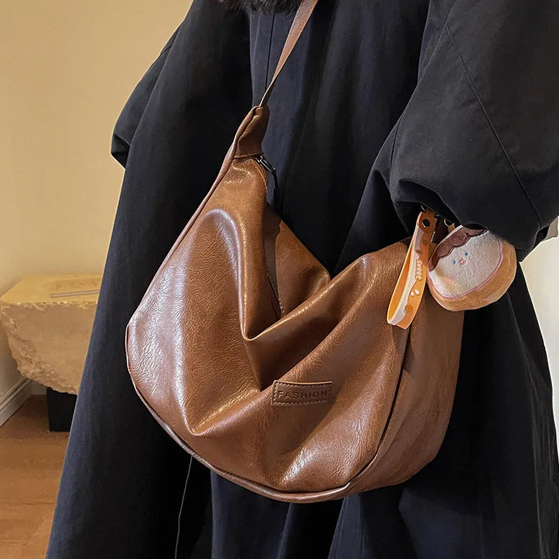 Retro PU shoulder messenger bag in dumpling shape with open pocket and sewing thread detail, black brown coffee options.