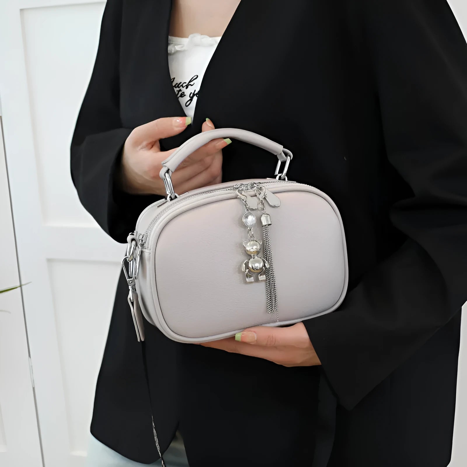 Oval-shaped women's small square shoulder bag in PU with double straps, shown in blue.