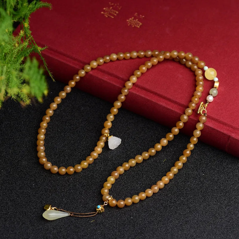 Women's green jade bead bracelet with leaf motifs and sequin details