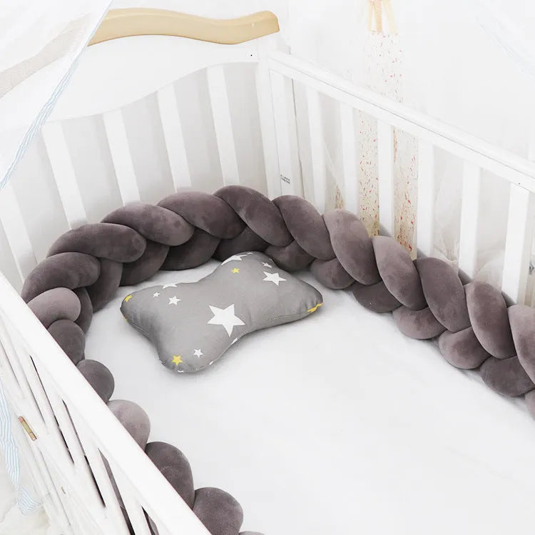 Spandex crystal velvet baby cot bumper in grey pink colour, shown flexible and long.