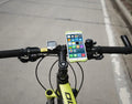 Silicone bicycle phone holder mounted on handlebar showing three-hole adjustment system