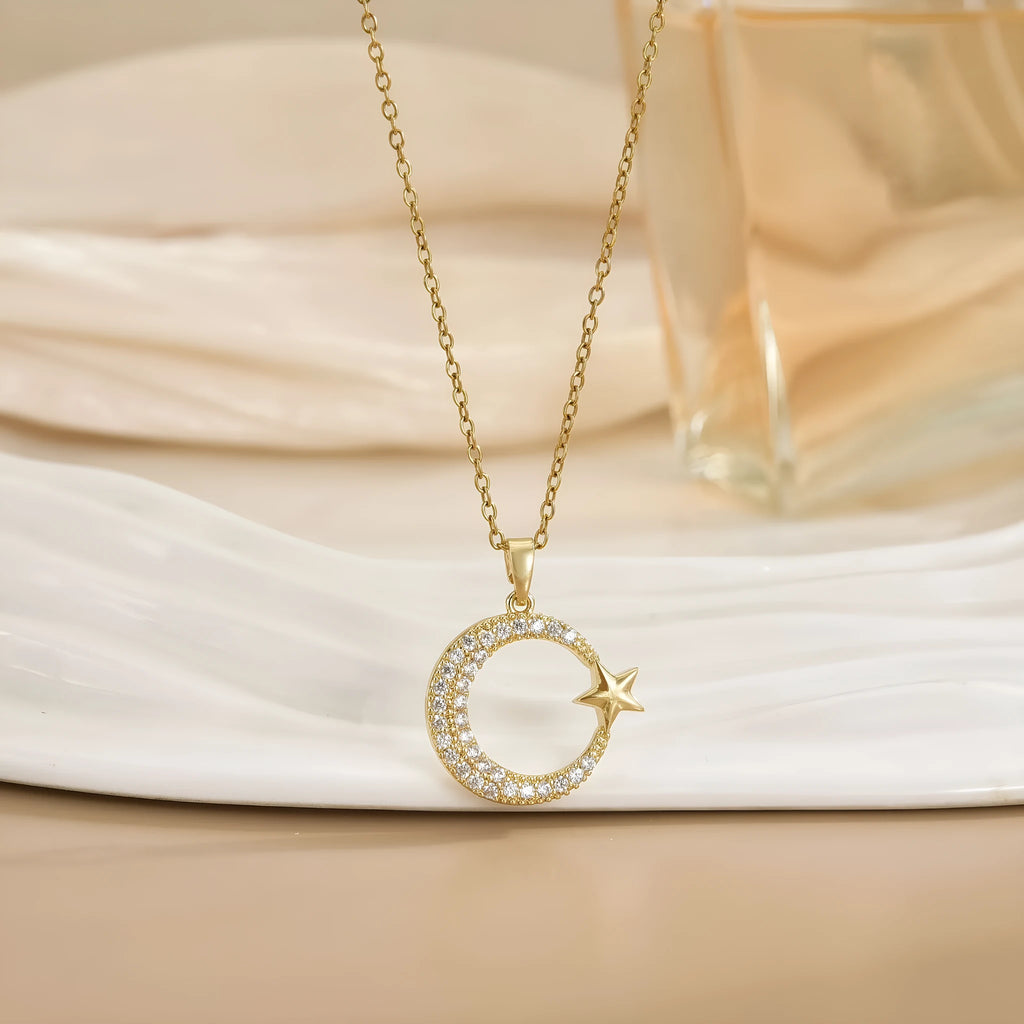Xingyue gold geometric moon pendant necklace with zircon stone on titanium steel O-ring chain against white background