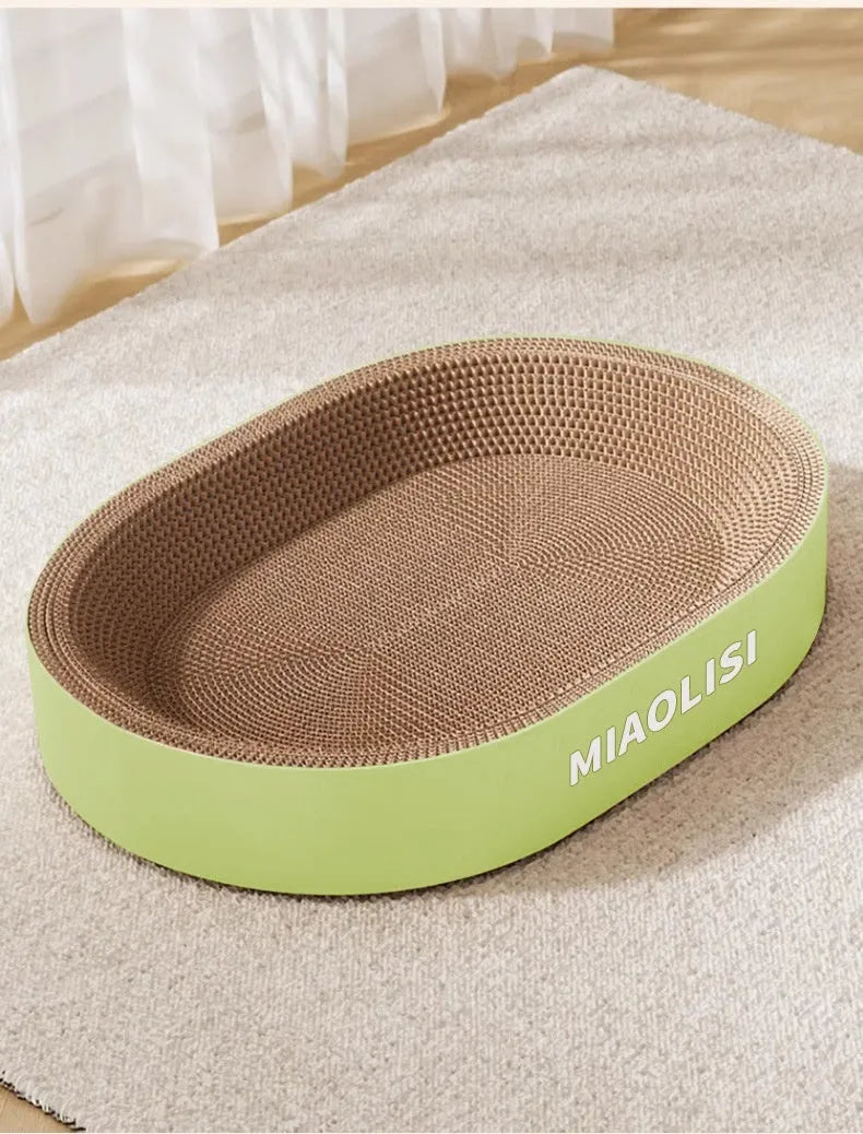 Green oval corrugated paper cat scratch board and nest, 55cm in diameter.