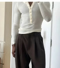 Men's cream-coloured ribbed long-sleeve henley top with a three-button placket.