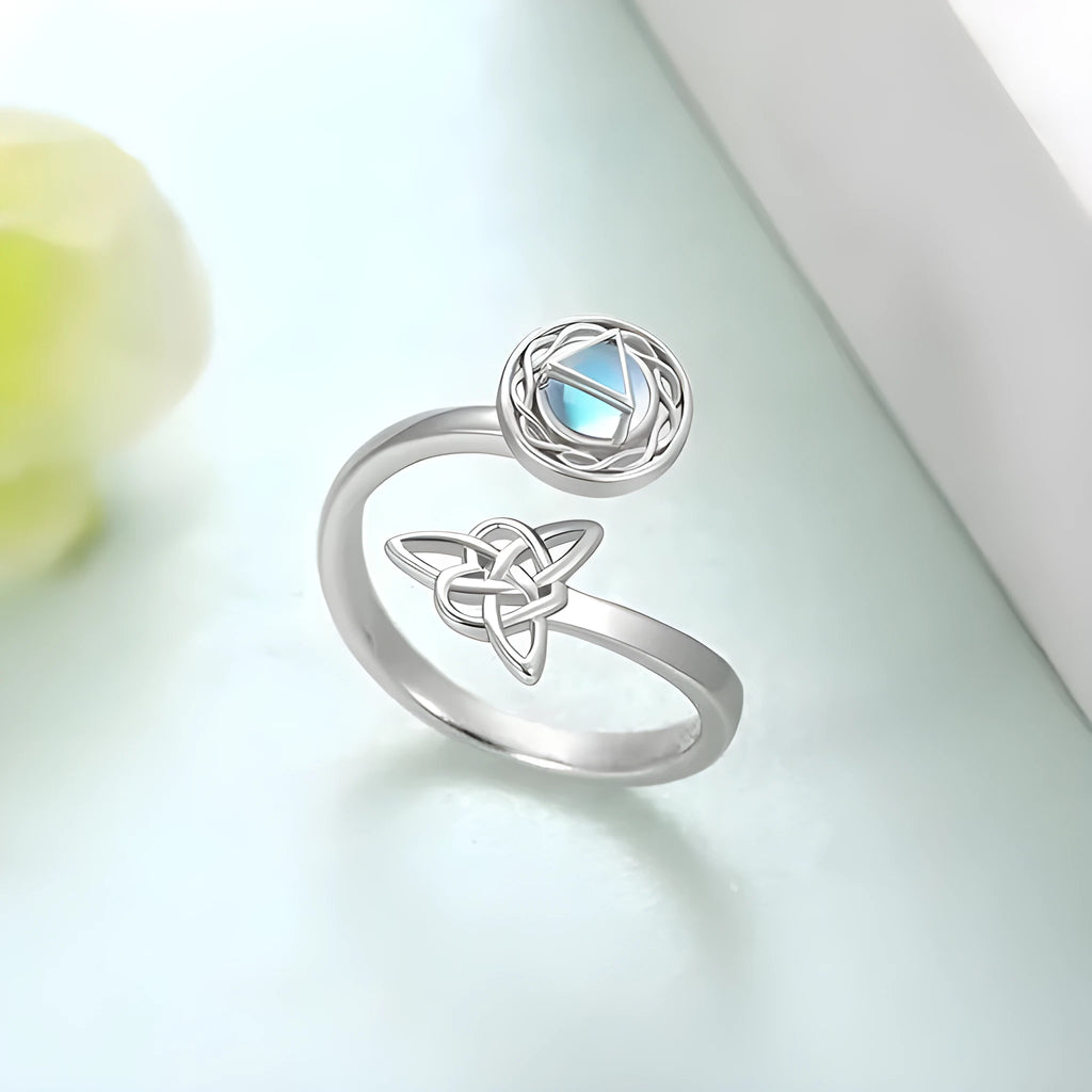 Rotating moonstone ring bracelet in white gold colour with adjustable opening and geometric circle and triangle design