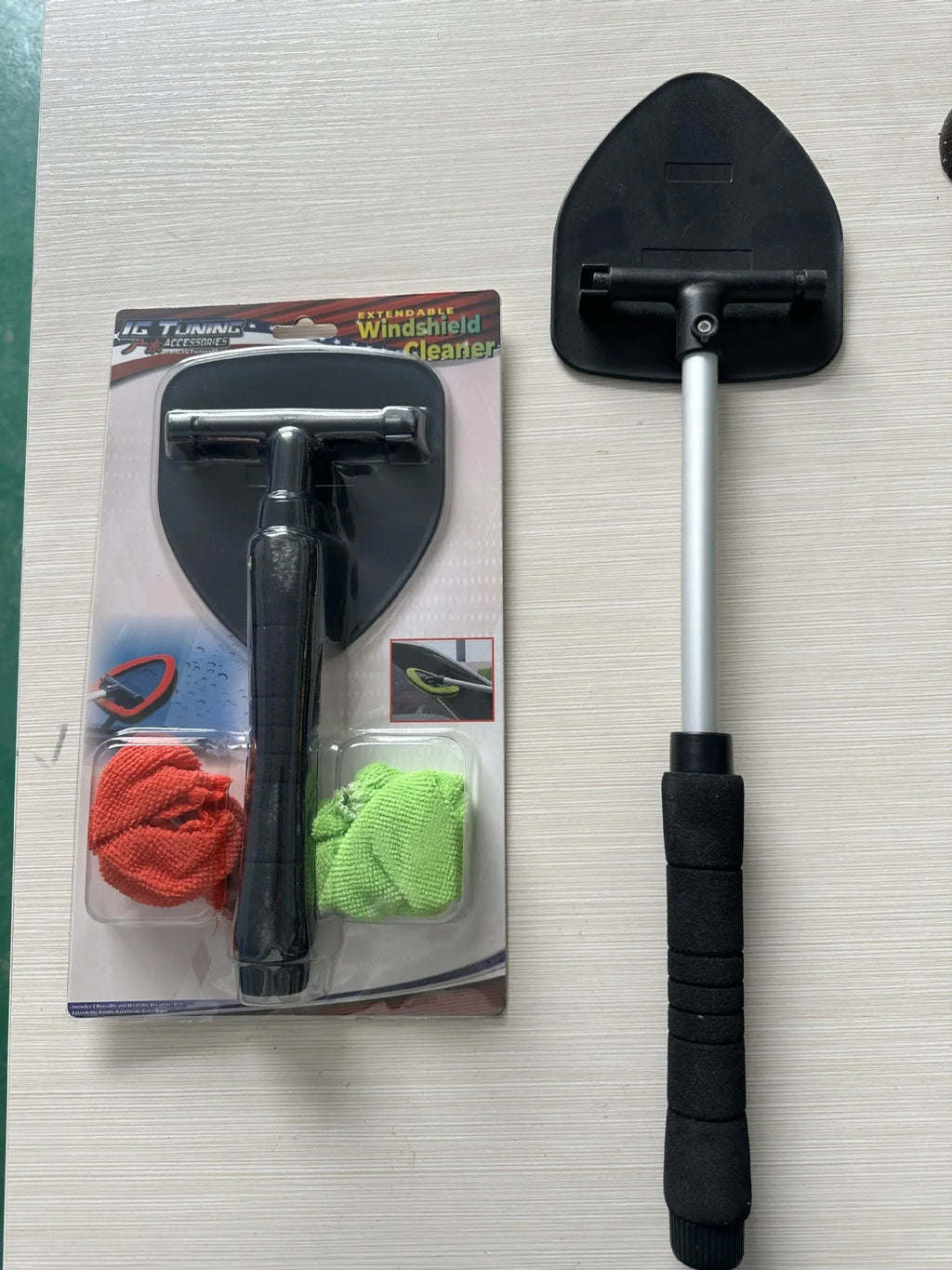 Plastic car windshield cleaning brush in choice of green, red, or sapphire blue colours