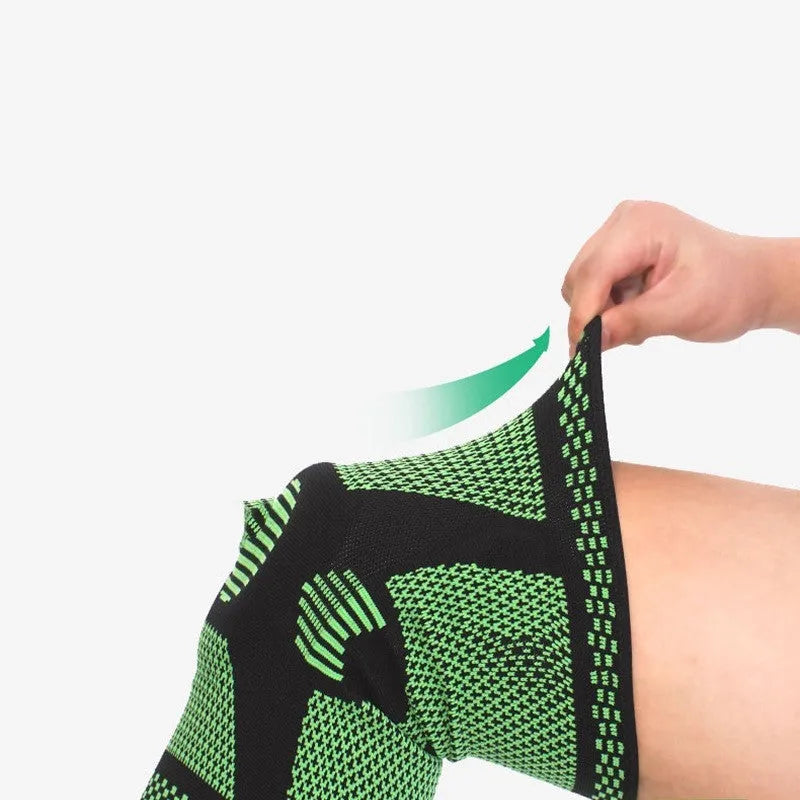 Blue sports knee pad with a visible silicone spring circle on a polyamide sleeve.