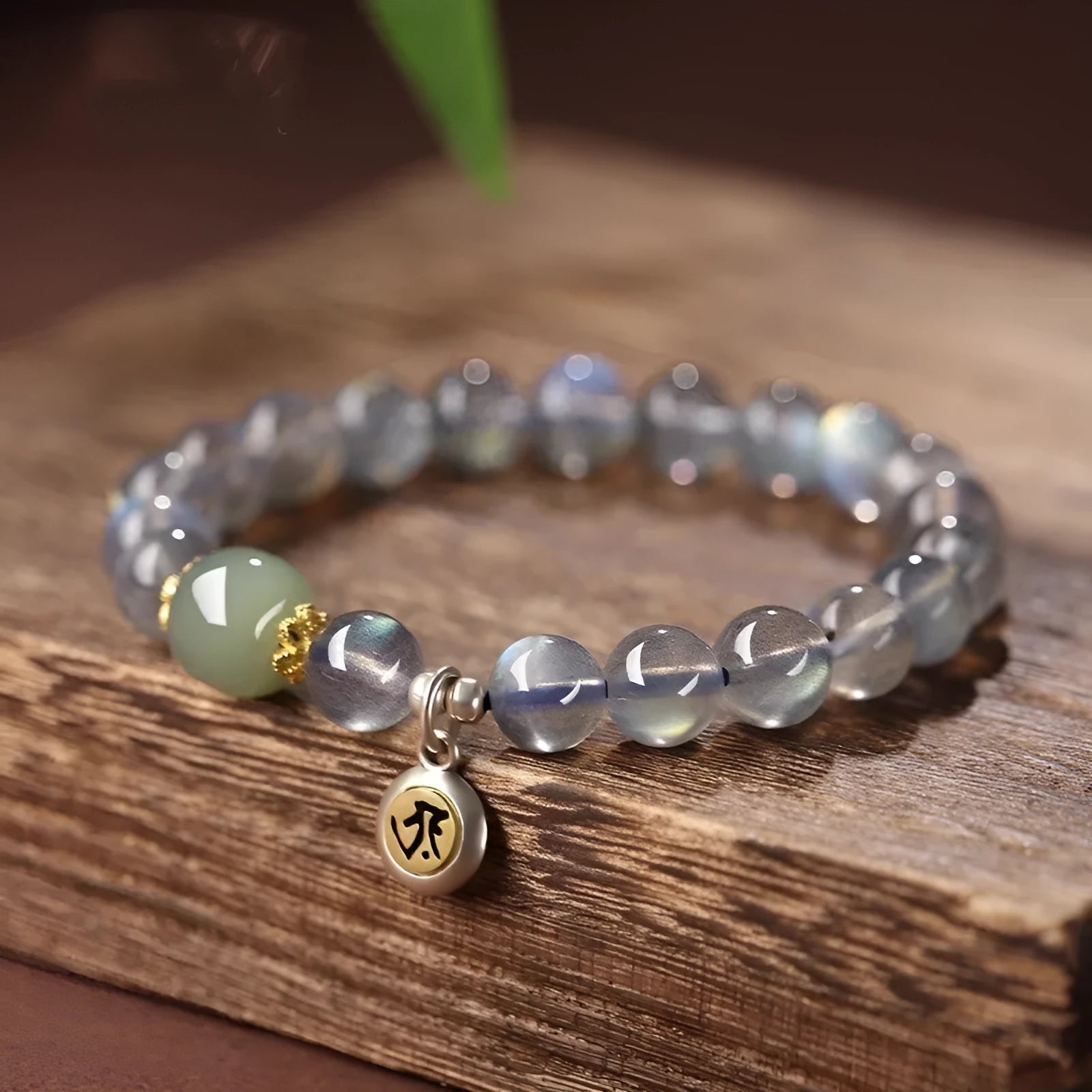 Moonstone women's bracelet with 8mm beads showing Thousand-Hand Kwan-yin mouse zodiac design and electroplated metallic finish