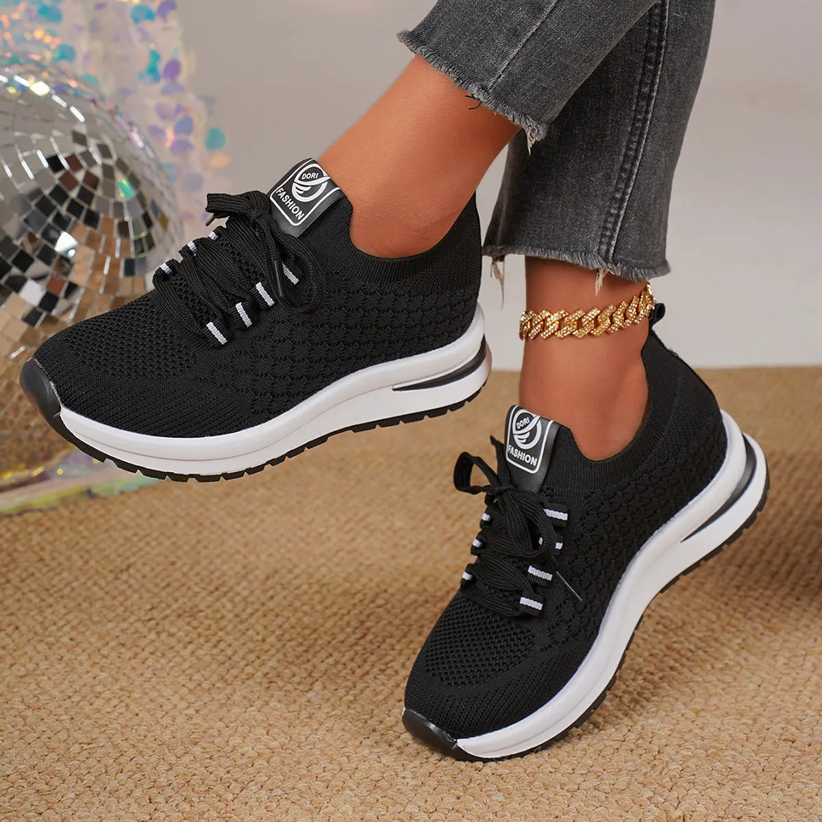 Women's black mesh lace-up sneakers with flat rubber sole and round toe