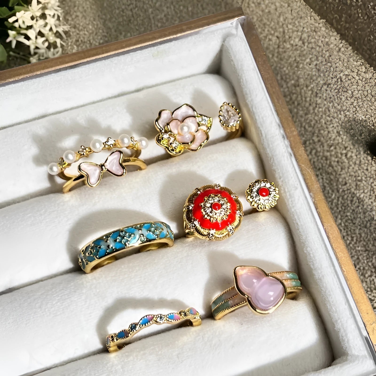 A copper vintage-style ring with a gourd motif, floral and bow designs, inlaid zircon stones, and an adjustable opening.