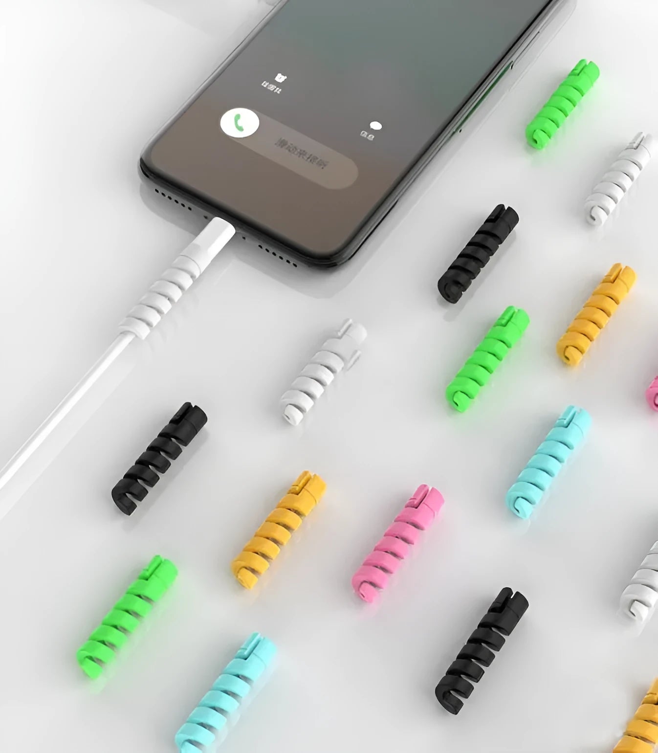 Plastic charging cable protector in various colours, showing its 3.5cm length.