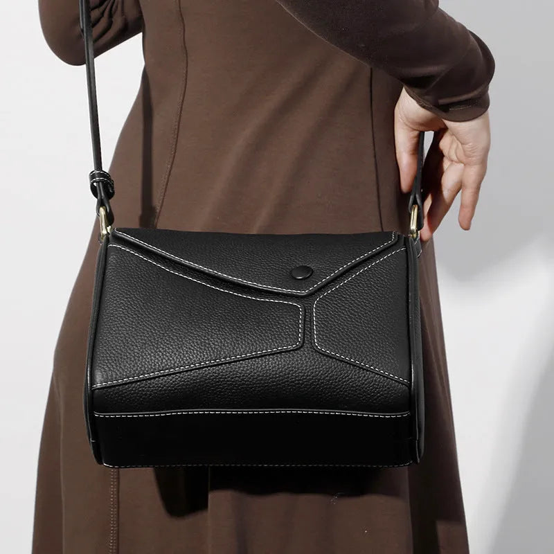 Women's genuine leather crossbody bag in soft first layer cowhide, square shape, 22x11x15cm, black colour option on a plain background