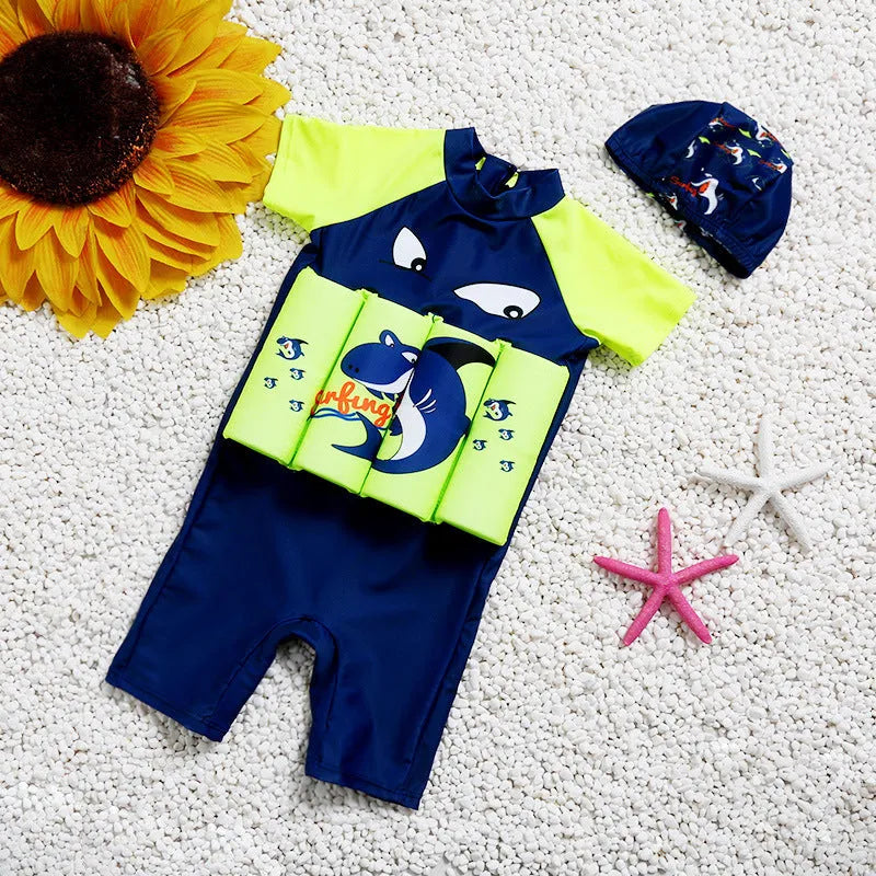 Child wearing a Shark Boy cartoon design buoyancy swimsuit in a swimming pool.