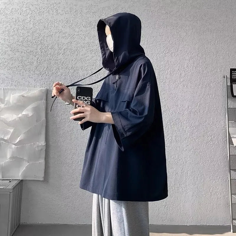 Man wearing a loose fit black hooded short sleeve T-shirt for summer.