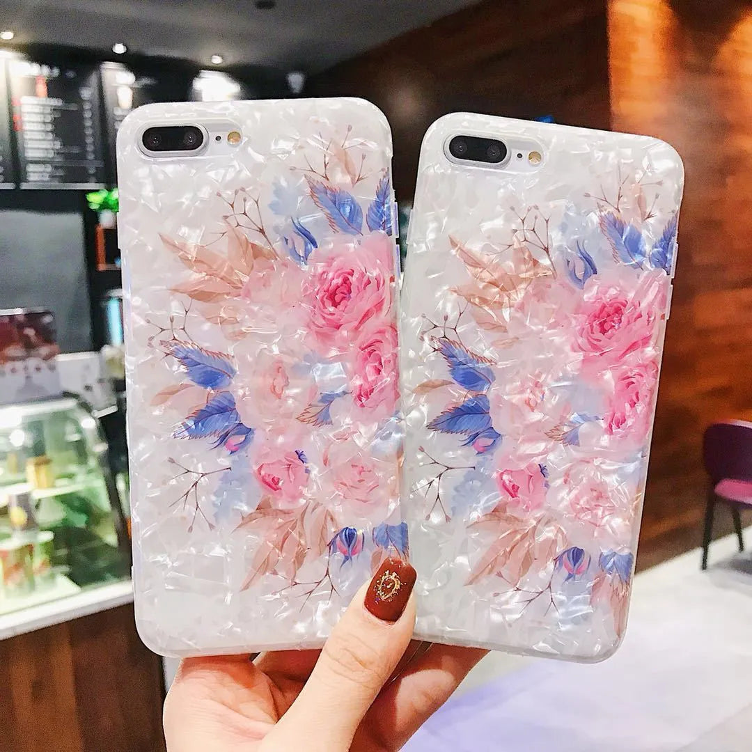 Dream Shell soft TPU iPhone case with rose flower design in purple, shown on a phone.