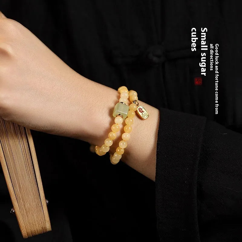 Women's hand-woven topaz bracelet with mantra barrel beads and square jade accents