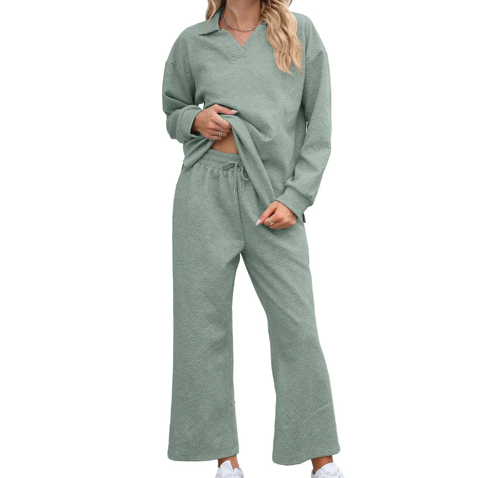 Women's solid colour knitted jacquard sweater and elastic waist trouser suit laid flat.