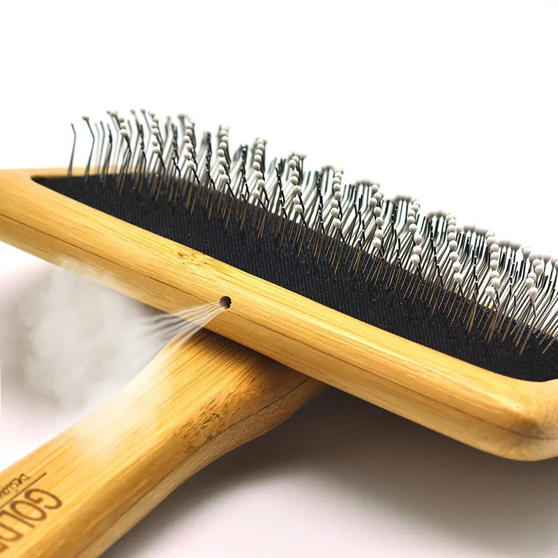 Pet grooming bamboo wood air cushion needle comb in original bamboo colour with steel pins, shown on a table