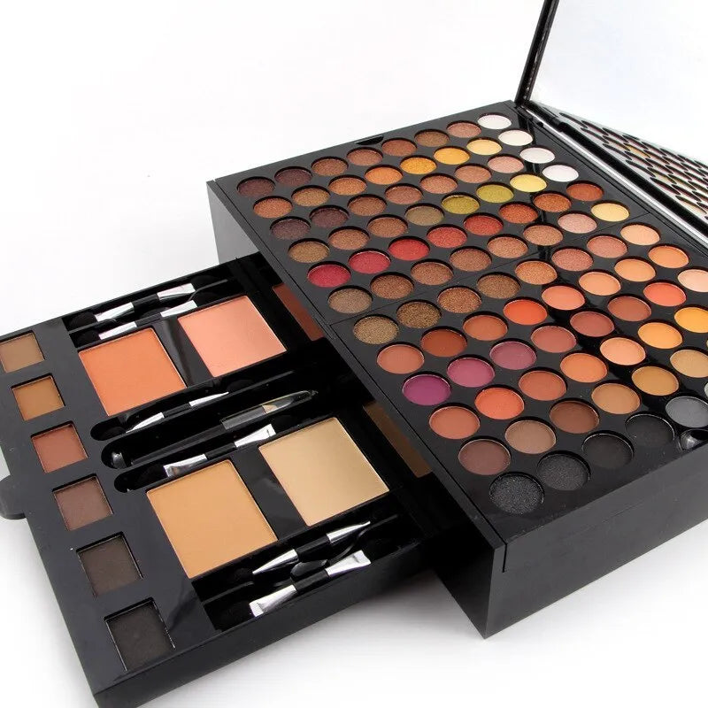 Piano-shaped makeup palette open to show 180 eyeshadows, blushes and powders inside.