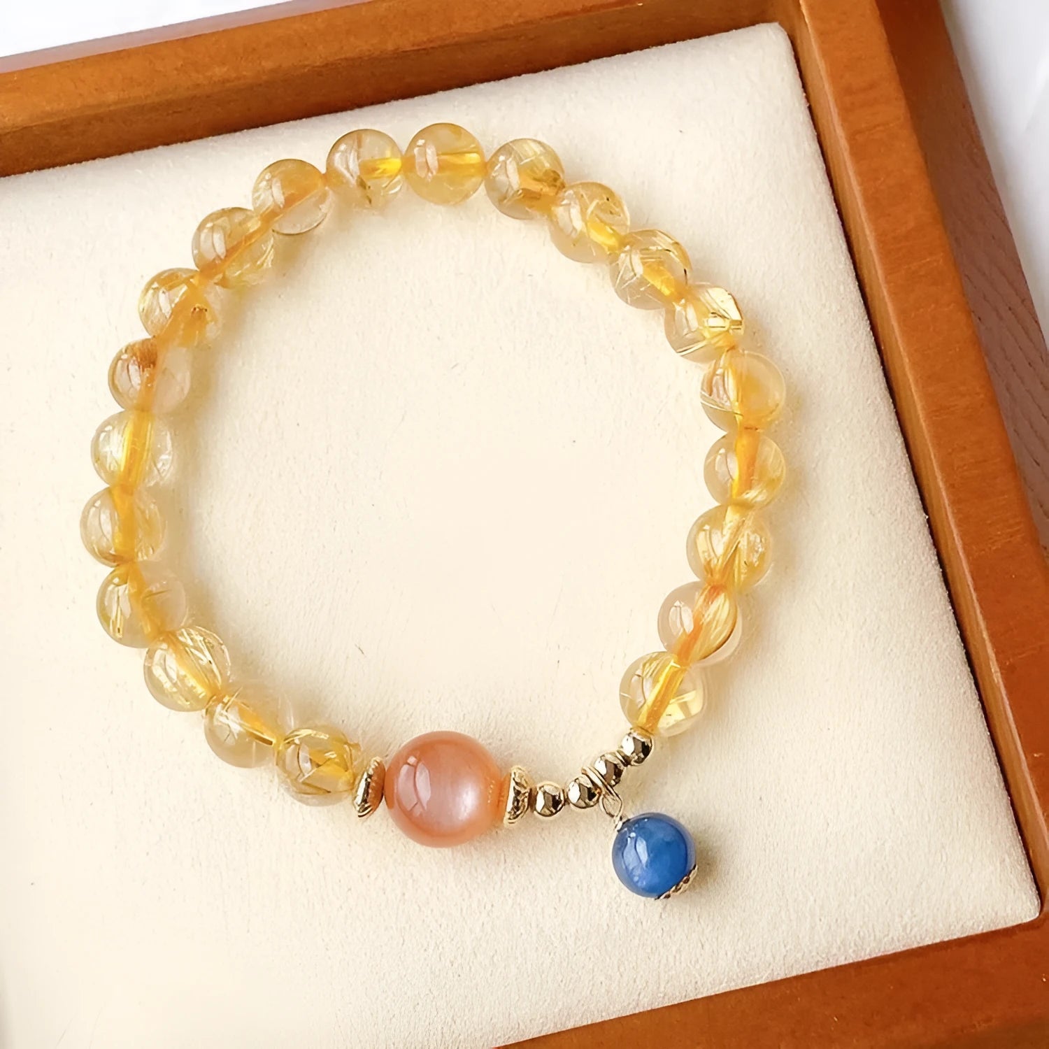 Women's gold rutilated quartz sunstone crystal bracelet with diamond-shaped and round beads