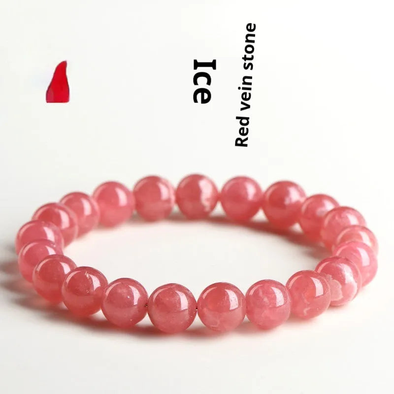 Women's geometric rhodochrosite crystal bracelet with a Longevity Lock clasp on a wrist.