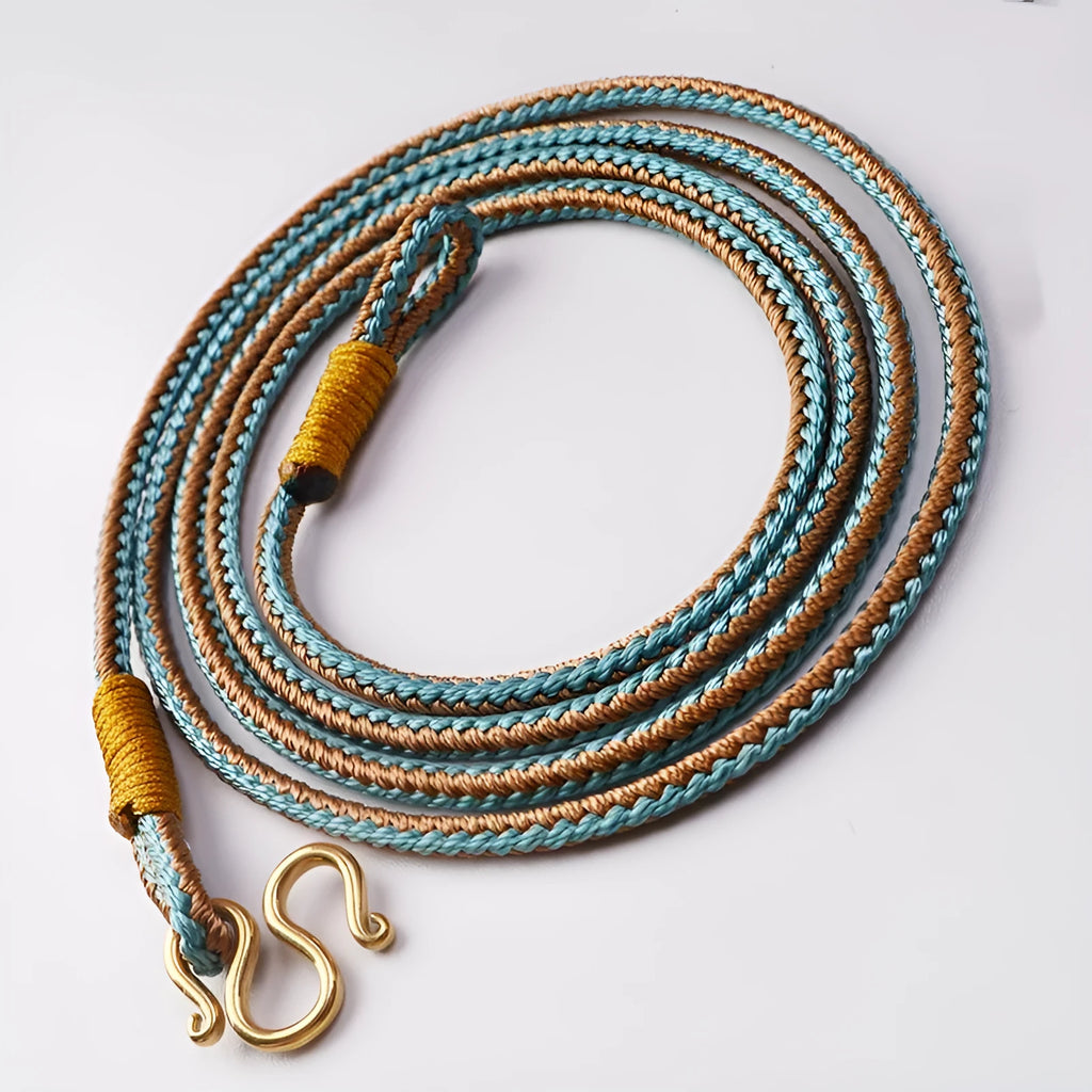 Gold and silver adjustable imitation pearl peace buckle with mixed gemstone inlaid pendant on a wrist.