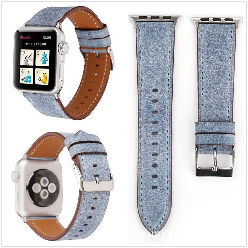 Genuine leather watch strap with a folding buckle in various colours on a grey background.
