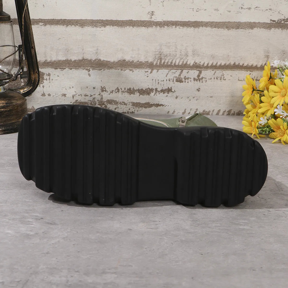Women's black platform Martin boots with patchwork detail and side zip on a white background.