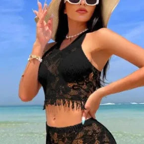 Women's white lace bikini top with matching tassel skirt two-piece swimsuit set on beach