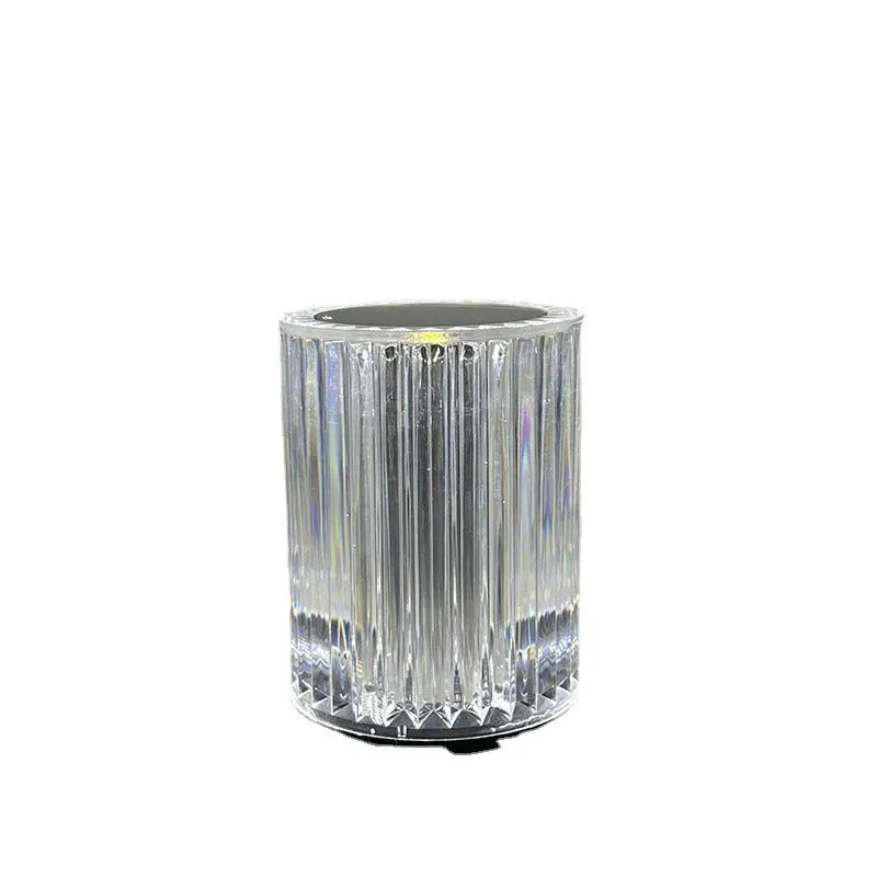 Compact acrylic crystal LED table lamp with RGB colours and remote control on a desk