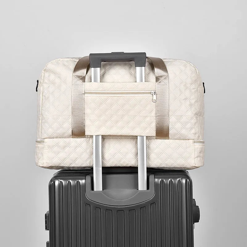 Large oxford cloth travel bag in a solid colour with visible sewing thread details, shown with the main compartment open.