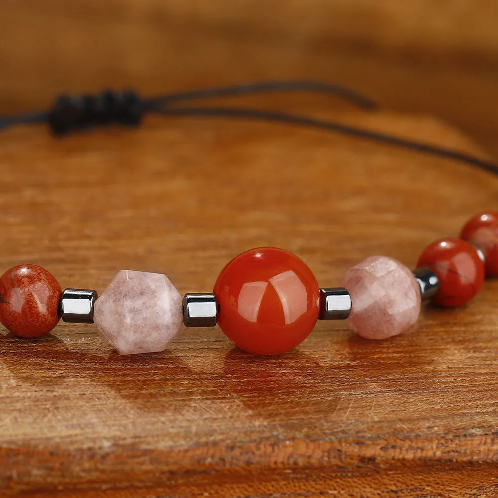 Handmade red crystal bracelet with sunstone, redstone and copper beads in a geometric design.