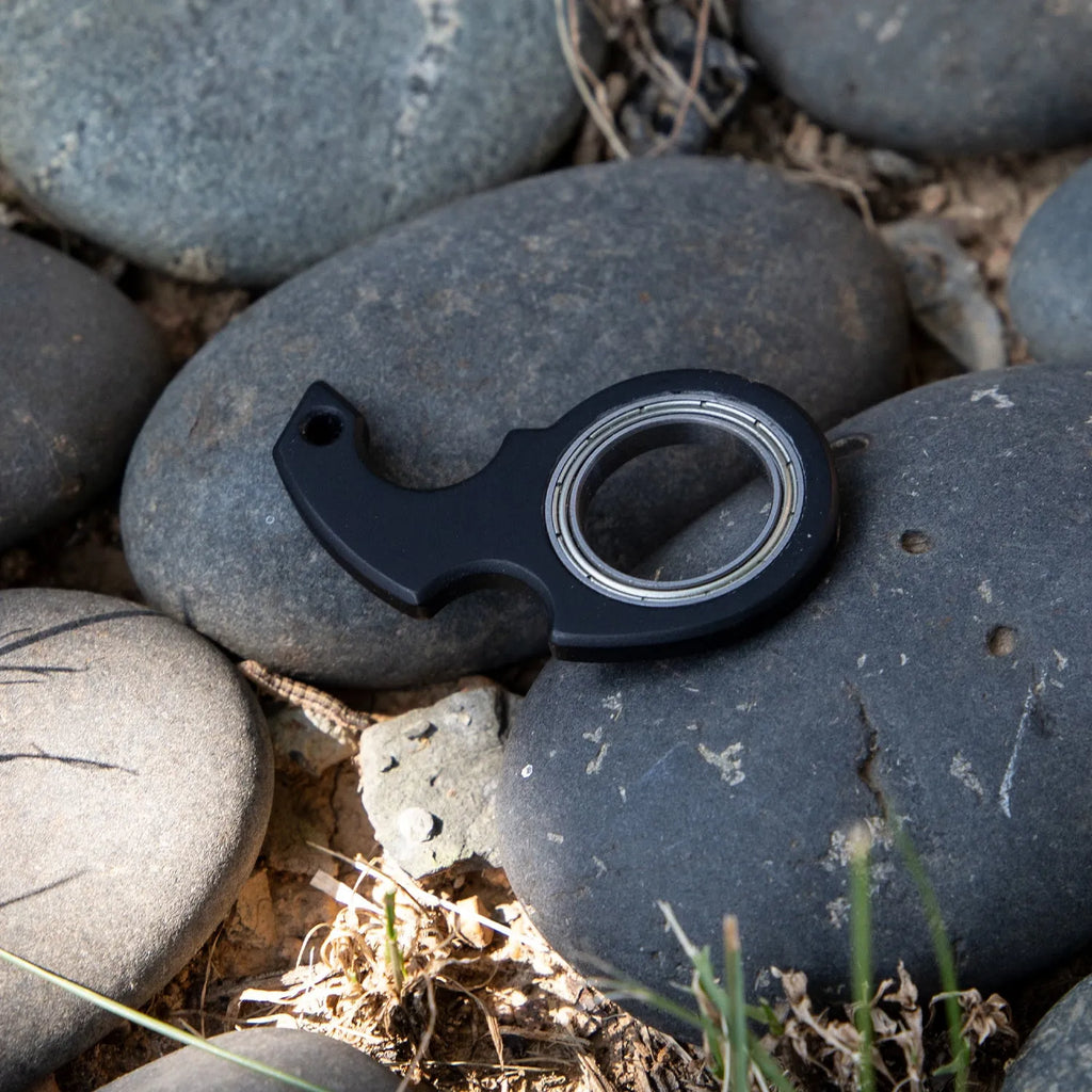 Creative fidget spinner keychain in black with plastic and zinc alloy construction, featuring a bottle opener