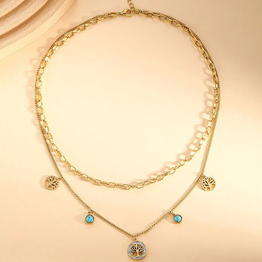 Gold titanium steel multi-layer box chain necklace with turquoise accent on model