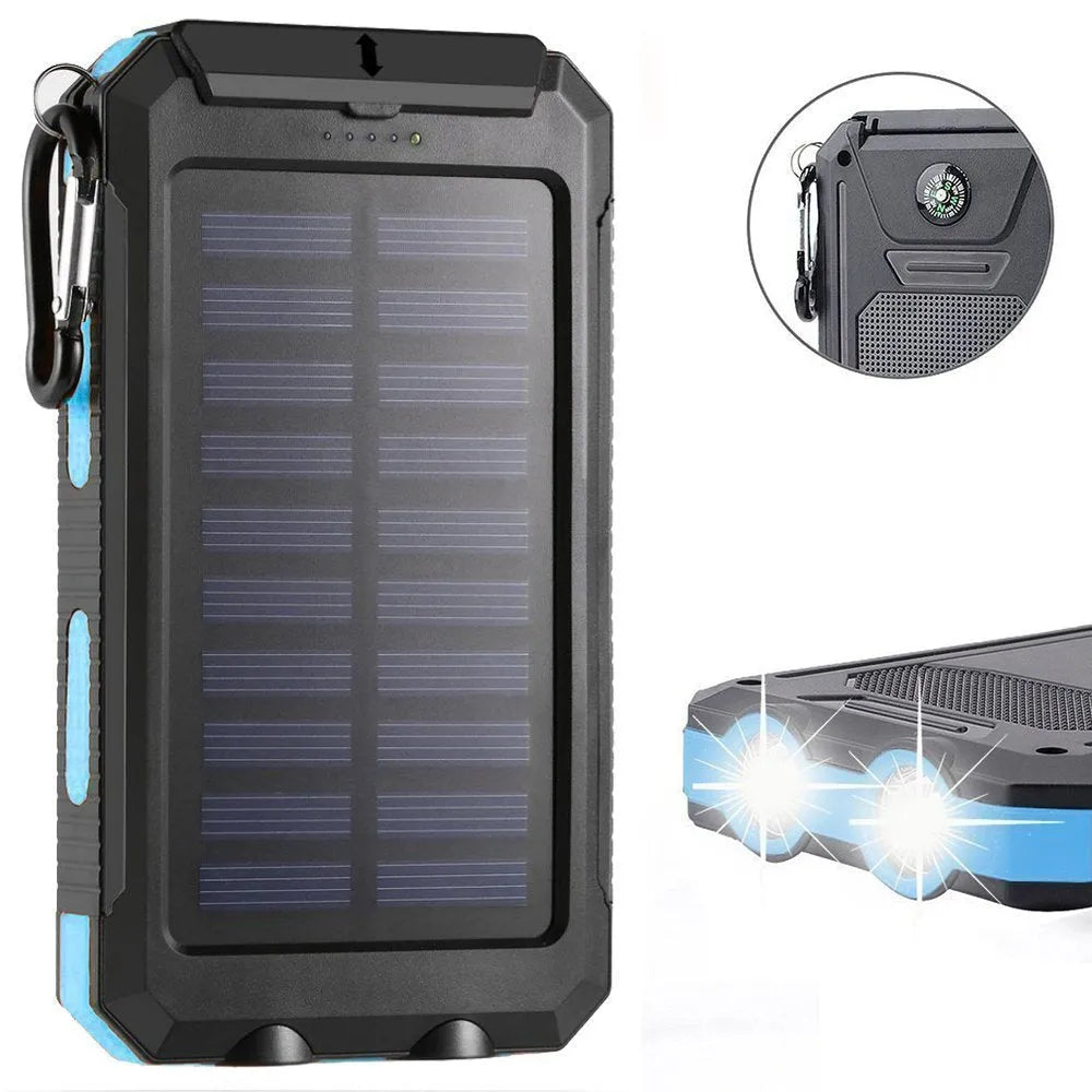 Black solar power bank showing LED flashlight, digital compass display, and solar panel on a rugged outdoor surface.