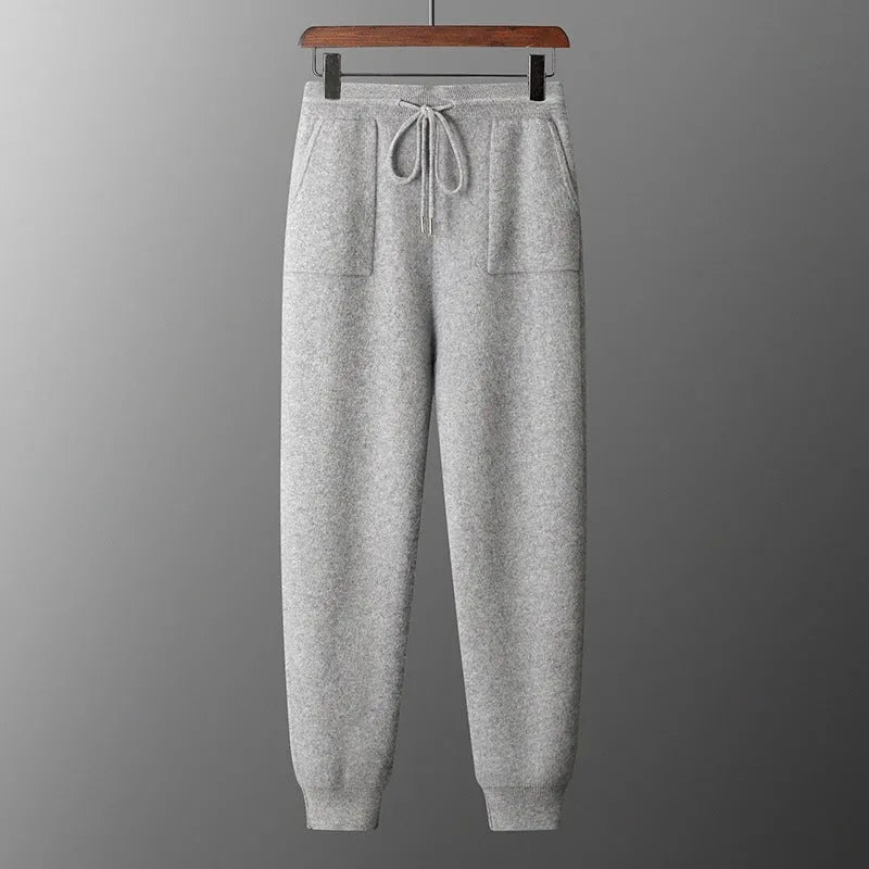 Men's light grey cashmere hooded sweatshirt and matching trousers laid flat.
