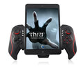 Black telescopic wireless game controller extended holding a mobile phone