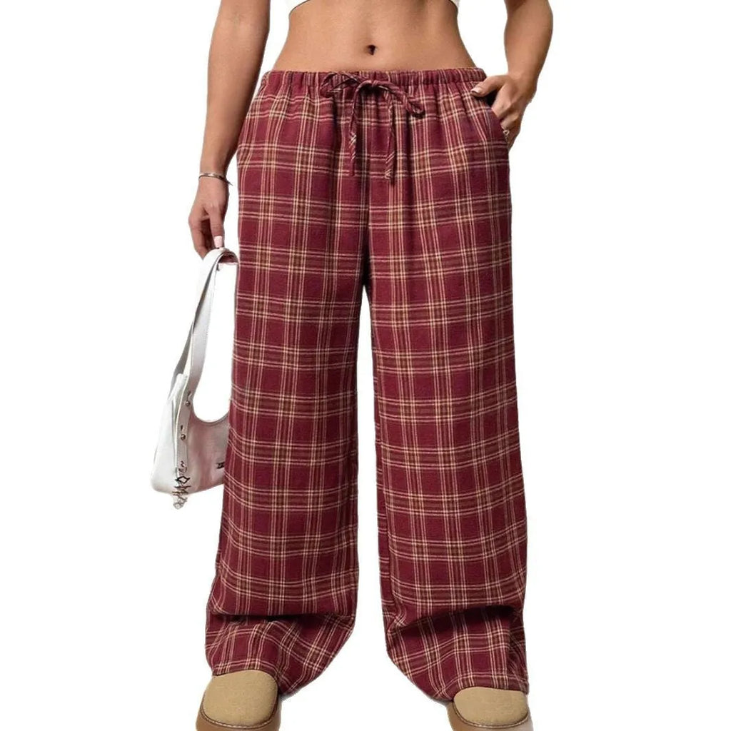 Women's blue plaid trousers with elastic drawstring waist and patch pockets laid flat