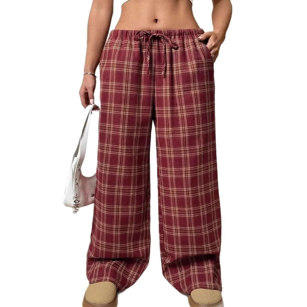 Women's blue plaid trousers with elastic drawstring waist and patch pockets laid flat