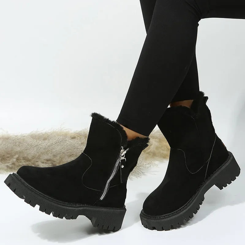 Women's black faux suede high-top snow boots with side zip and thick faux fur lining visible at the ankle.