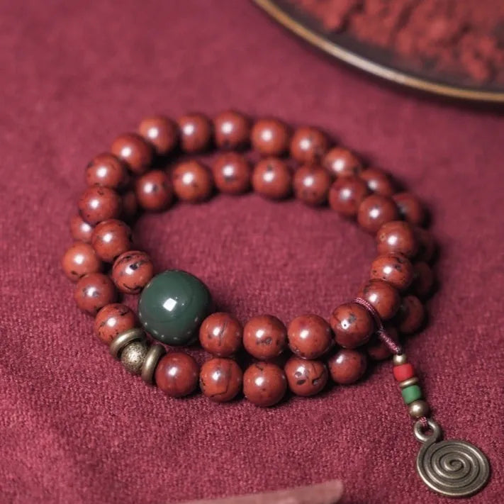 Close-up of a handmade double circle bracelet crafted from brown bodhi seeds on a wrist.