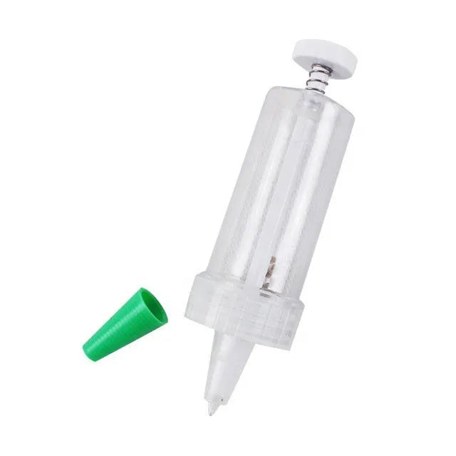 A white plastic mini seeder tool measuring 12cm long, used for planting seeds in pots and trays.