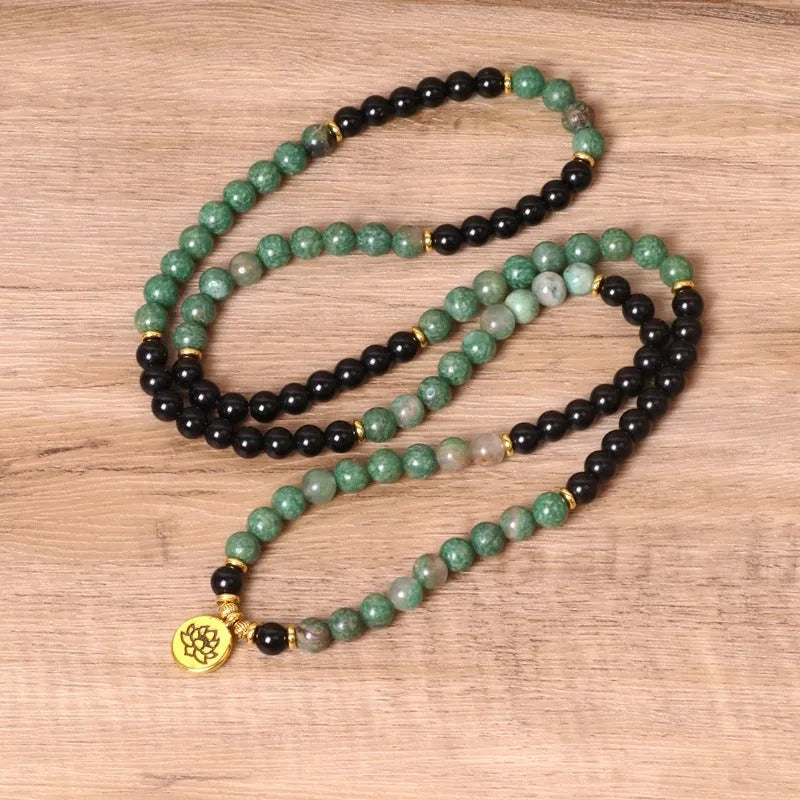 Green and black elastic beaded bracelet with alloy construction