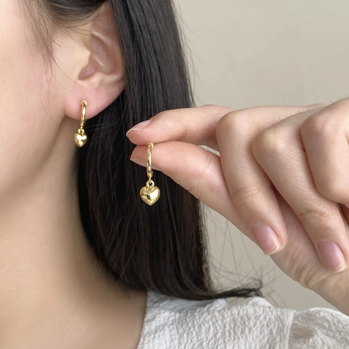 Copper heart-shaped earrings in gold and silver electroplate, available as ear clips or studs for women