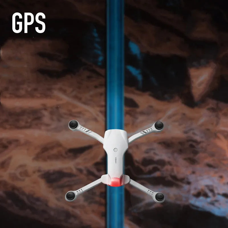F10 folding GPS drone with 6K dual camera unfolded on a table showing propellers and camera