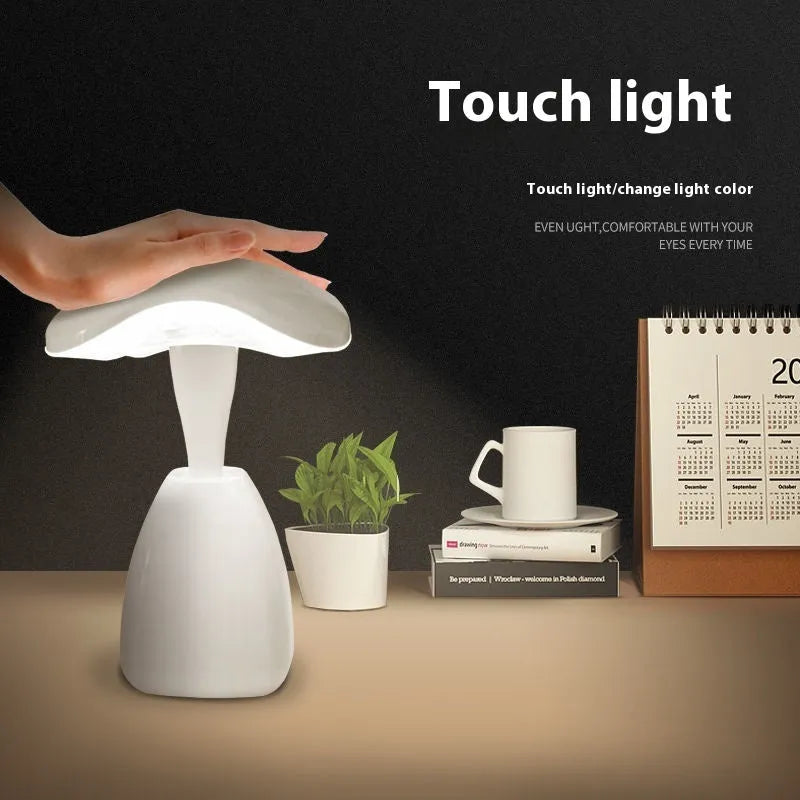 White modern LED desk lamp with plastic shade and touch controls on wooden desk
