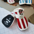 Four blue cloth dog sneakers with zipper closures arranged on a white background