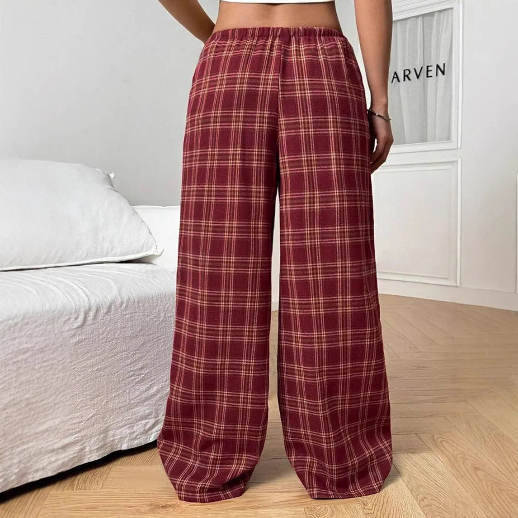 Women's blue plaid trousers with elastic drawstring waist and patch pockets laid flat